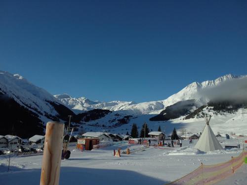 a group of people on a snow covered mountain at Tgèsa Felici in Sedrun