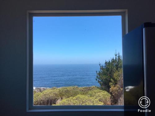 a view of the ocean through a window at Tunquen Magico in Tunquen