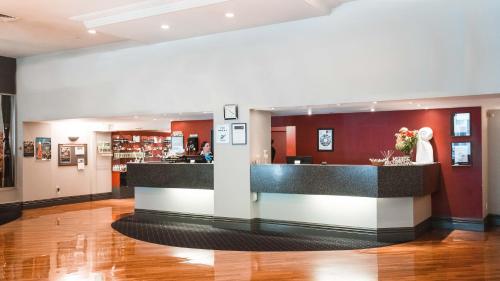 a lobby with a counter in a building at Scenic Hotel Southern Cross in Dunedin