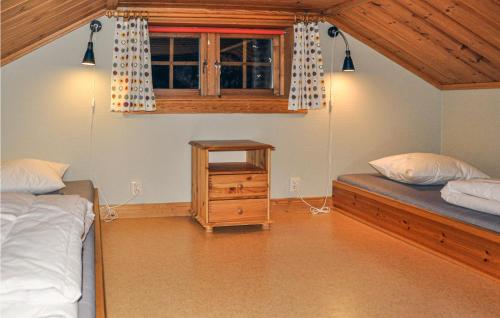 a bedroom with two beds and a window at Beautiful Home In Slen With House A Mountain View in Sälen