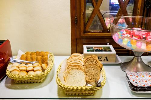 two baskets of bread and pastries on a table at Pousada Don Diego in Ubatuba