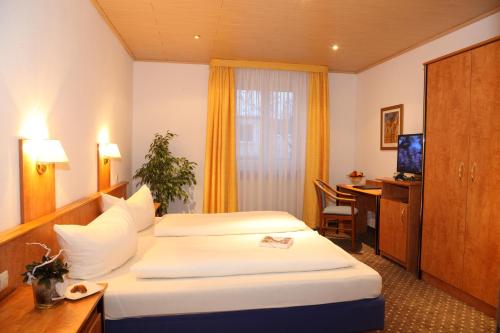 Ein Bett oder Betten in einem Zimmer der Unterkunft Garni-Hotel Goldenes Lamm