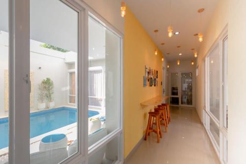 a house with a swimming pool and a hallway at Omah Manis in Yogyakarta