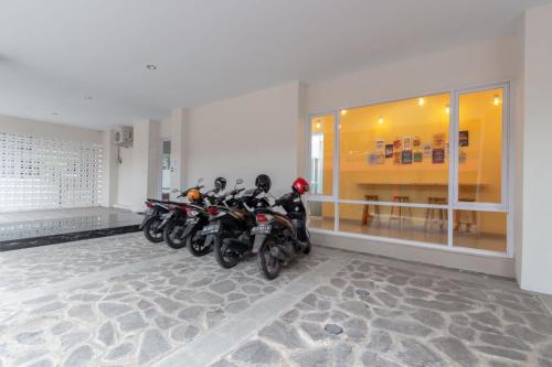 a row of motorcycles parked in a room at Omah Manis in Yogyakarta