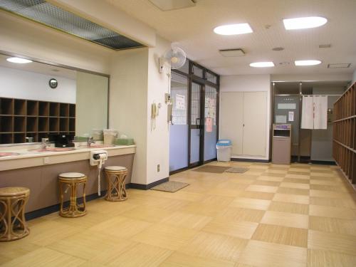a large room with a kitchen with stools at Madarao Kogen Hotel in Iiyama