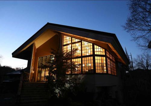 a building with a large window on the side of it at Hotel Mount Shiga in Yamanouchi