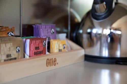 a counter top with a shelf with books on it at Alpine Lake Motel in Taupo