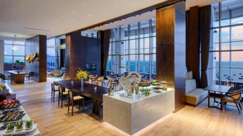 a dining room with a view of the ocean at Crowne Plaza Beihai Silver Beach by IHG in Beihai
