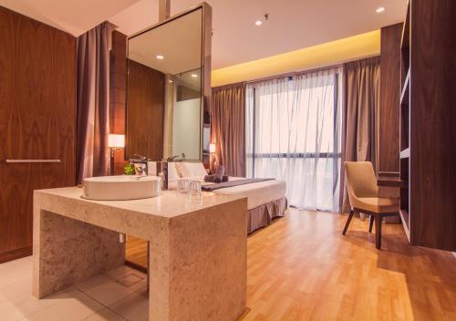 a bathroom with a sink and a bed in a room at D'majestic Place by Homes Asian in Kuala Lumpur