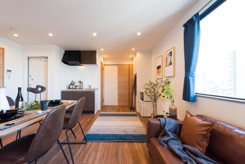 a living room with a couch and a table at TORA HOTEL Tokyo Skytree 寅ホテル スカイツリーG in Tokyo