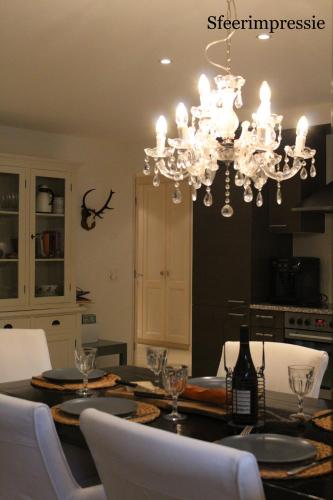a dining room with a table and a chandelier at Edelweiss A13 in Morgins