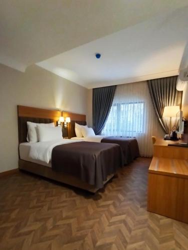 a hotel room with two beds and a window at AK LİFE HOtEL in Ankara