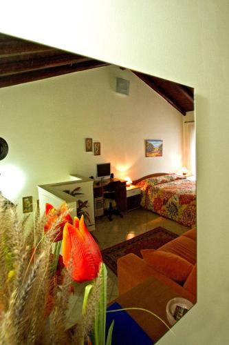 a bedroom with a bed and a desk and a room at Etna Snow&Sea in Piedimonte Etneo