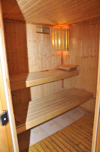 a wooden sauna with wooden shelves in it at Villa Ibar in Borovets