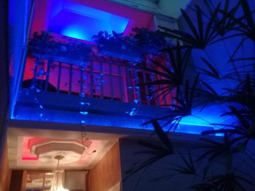 a building with a blue and red lights on a balcony at Hotel Gilda in Buenos Aires