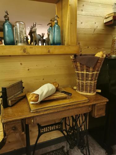 a wooden table with a cutting board and a knife at Hôtel Du Midi in Thônes