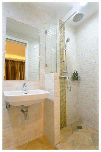 a bathroom with a sink and a shower at 4M Pratunam Hotel in Bangkok