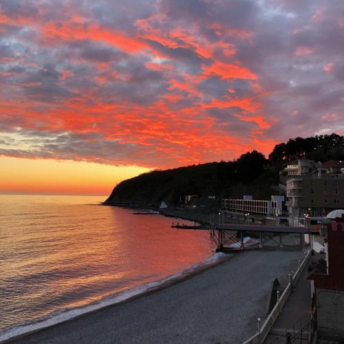 a view of a beach with a sunset at Kavkaz Hotel in Olginka