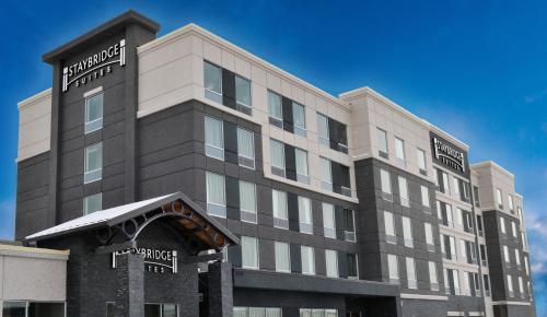 a large building with a sign for a hotel at Staybridge Suites - Red Deer North by IHG in Red Deer