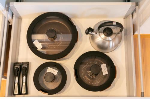 a shelf with a pot and pans and utensils at 白馬パウダーマウンテン in Hakuba