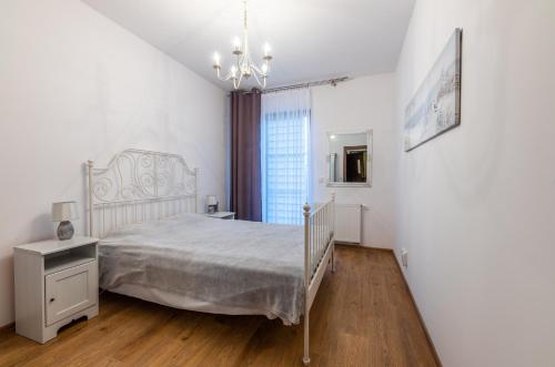 ソポトにあるVictus Apartamenty, Apartament Cadena 2の白いベッドルーム(ベッド1台、窓付)