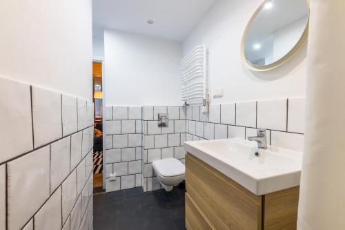 a bathroom with a sink and a toilet at Victus Apartamenty Apartament Bolek i Lolek in Sopot