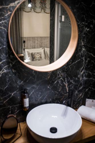a bathroom with a white sink and a mirror at Hotel Pok Garni in Brezovica