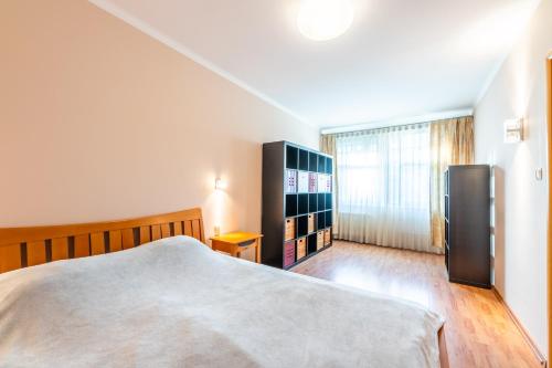a bedroom with a bed and a book shelf at Glow Apartments, Apartament Meriwa Sopot in Sopot
