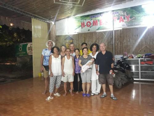 a group of people posing for a picture in a room at Tam Coc White Swan Homestay in Ninh Binh