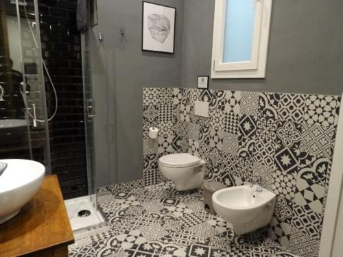 a bathroom with a toilet and a sink at Savieri Home in Florence in Florence