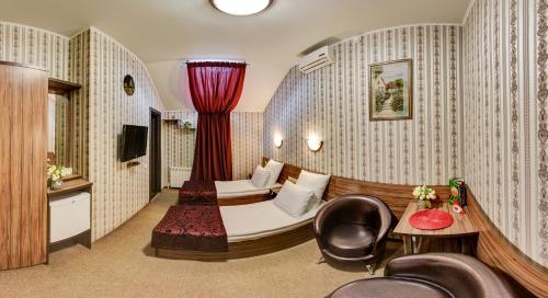 a hotel room with a bed and a chair at Zvezda Guest House in Saratov