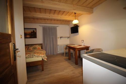a kitchen and a living room with a table at Apartmány u Knajflů in Petrovice
