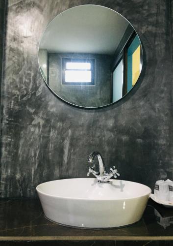 a bathroom with a sink and a mirror at The Sun Long Beach Resort in Ko Lanta