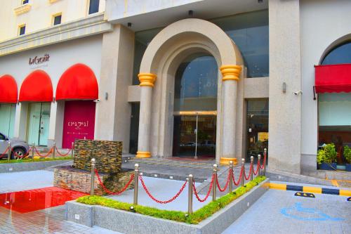 a building with a red ribbon in front of it at One to One Hotel in Al Khobar