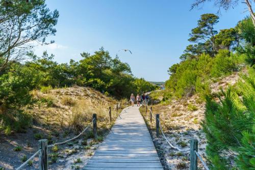 a boardwalk leading up to the beach on a sunny day at Sol Parc Hotel & Apartments in Son Parc