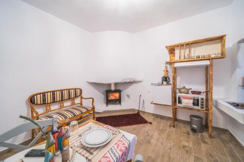 a living room with a bed and a fireplace at Krassopsychia Apartments in Krásion