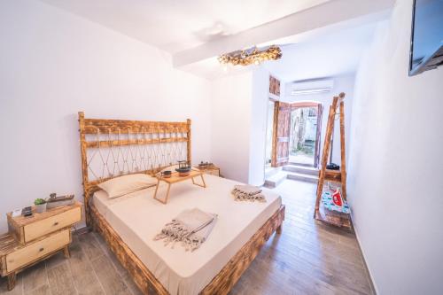 a bedroom with a bed with a wooden headboard at Krassopsychia Apartments in Krásion