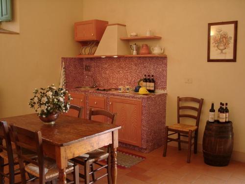 a kitchen with a table and a counter top at Agriturismo La Capitata in Pian di Scò