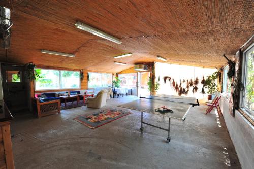 a living room with a table in the middle at Arbel Holiday Homes in Arbel