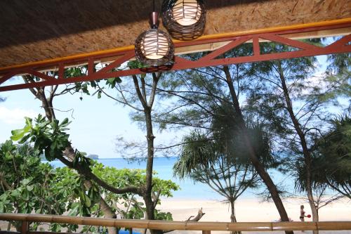 a view of the beach from a resort with two lights at Ruan Mai Naiyang Beach Resort in Nai Yang Beach