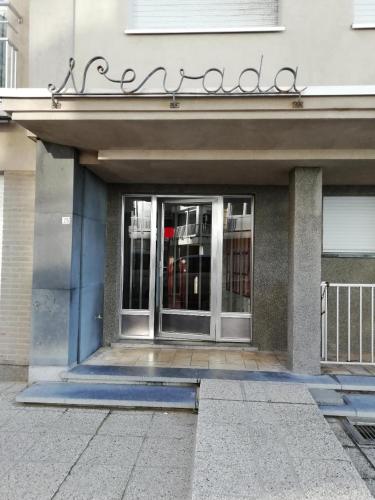 an entrance to a building with a glass door at Nevada in Koksijde