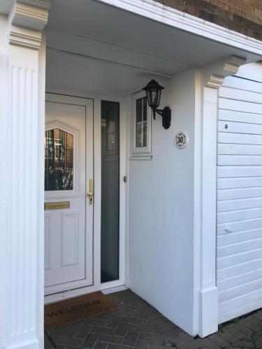 a white door leading to a white garage at Cozy Homestay in Croydon