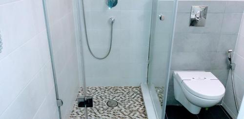 a small bathroom with a shower with a toilet at Shalanda in Odesa
