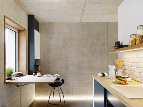 a kitchen with a counter and a stool in a room at ipartment Cologne Muelheim in Cologne