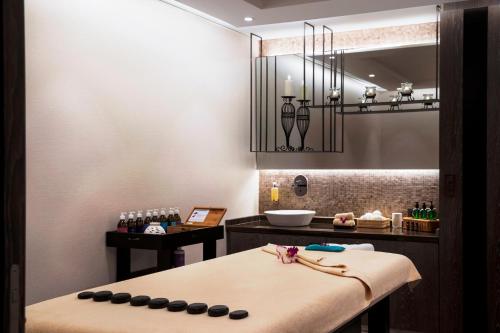 a spa room with a bench and a mirror at Al Maha Arjaan by Rotana in Abu Dhabi
