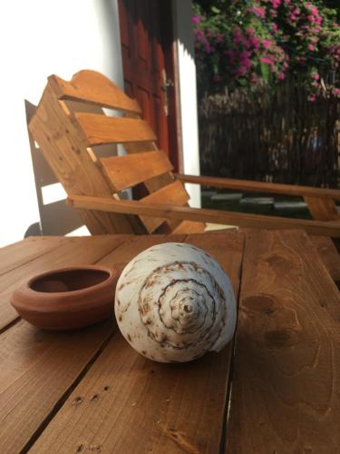 a white object sitting on a wooden table at Emma's Sea View in Hiriketiya
