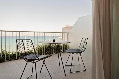 two chairs and a table on a balcony with the ocean at Posia Retreat & Spa UNA Esperienze in San Foca