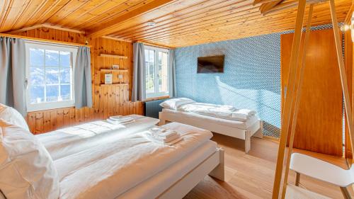 a bedroom with two beds in a room at Gasthaus Brünig Kulm in Brunig