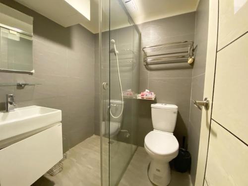 a bathroom with a toilet and a glass shower at Day Day Fengjia in Taichung