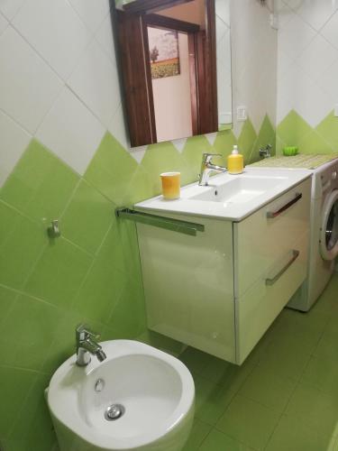 a bathroom with a sink and a toilet and a mirror at Appartamento Silvana in Grosseto